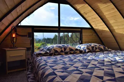 a bed in a room with a large window at Chalet Petit Verdot in Santa Elena