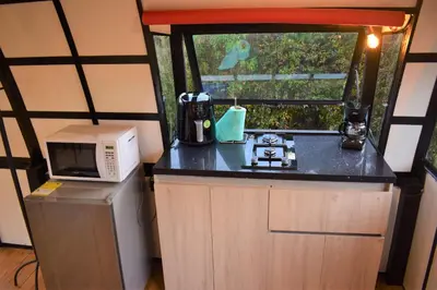 a small kitchen with a microwave and a refrigerator at Chalet Petit Verdot in Santa Elena