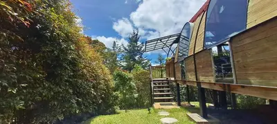 a house with a staircase next to a hedge at Chalet Petit Verdot in Santa Elena