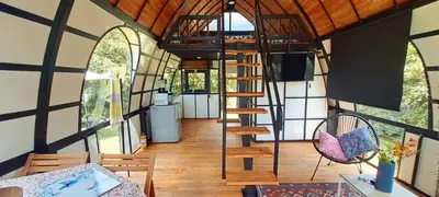 a room with a spiral staircase in a tiny house at Chalet Petit Verdot in Santa Elena