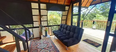 a living room with a couch and a large window at Chalet Petit Verdot in Santa Elena
