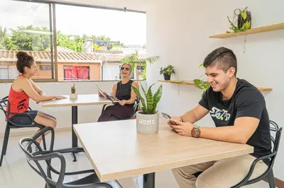a group of people sitting at tables in a room at Alojamiento Acogedor con excelente ubicacion D in Medellín