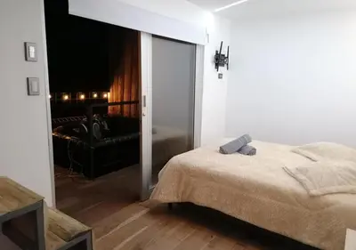 a bedroom with a bed and a sliding glass door at Hotel Cabañas y Chalets lujosos Mágica Luna Manizales in Villamaría