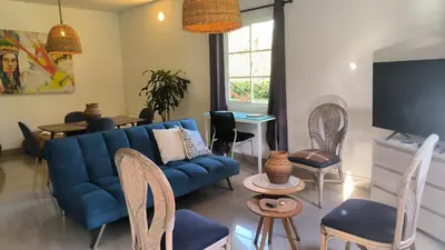 a living room with a blue couch and chairs at CASA HOTEL FIBA MAGUEZA in Guarne