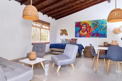 a living room with a couch and chairs and a table at CASA HOTEL FIBA MAGUEZA in Guarne