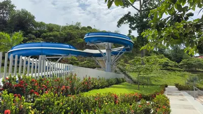 two slides in a garden with flowers at Stunning, Brand-new Apartment in Santa Fe de Antioquia