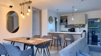 a kitchen and living room with a table and chairs at Stunning, Brand-new Apartment in Santa Fe de Antioquia