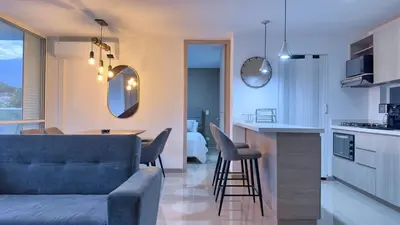 a living room and kitchen with a couch and a table at Stunning, Brand-new Apartment in Santa Fe de Antioquia