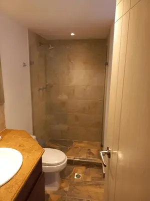a bathroom with a shower and a toilet and a sink at Poblado la 10 in Medellín