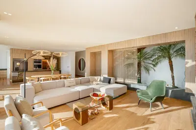 a living room with a white couch and a green chair at Hilltop Enchanting Villa with Stunning Views & Jacuzzi in Medellín