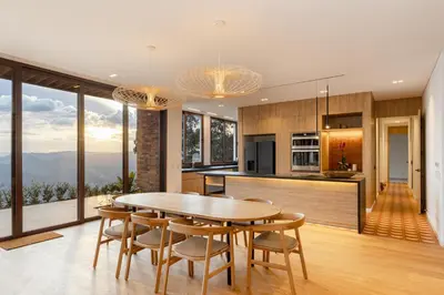 a kitchen and dining room with a table and chairs at Hilltop Enchanting Villa with Stunning Views & Jacuzzi in Medellín
