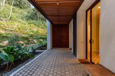 an entrance to a house with a wooden door at Hilltop Enchanting Villa with Stunning Views & Jacuzzi in Medellín