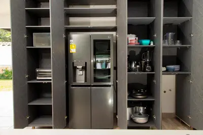 a metal refrigerator in a kitchen with shelves at Espectacular Villa en Copacabana in Copacabana