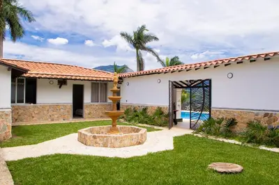 a house with a fountain in the yard at Espectacular Villa en Copacabana in Copacabana