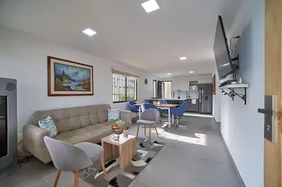 a living room with a couch and a table at Monte Hermoso - Apartamento campestre in Guatapé