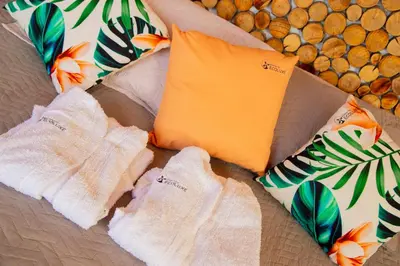 a pair of socks and a pillow on a bed at Glamping en Guatape Wifi Jacuzzi in Guatapé
