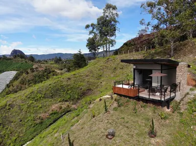 a small building on the side of a hill at Glamping en Guatape Wifi Jacuzzi in Guatapé