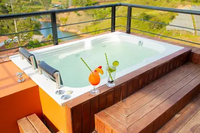 a jacuzzi tub on the deck of a house at Glamping en Guatape Wifi Jacuzzi in Guatapé