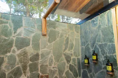a stone wall with three bottles on it at Glamping en Guatape Wifi Jacuzzi in Guatapé