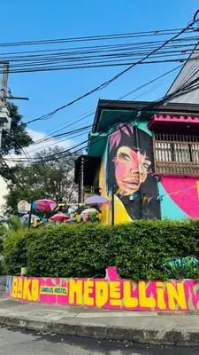 a building with a painting on the side of it at Baku Laureles Hostel in Medellín