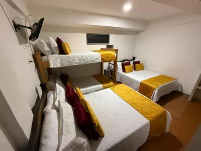 a room with three bunk beds in it at Ayenda Marana in Manizales