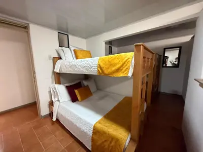 a room with two bunk beds and a couch at Ayenda Marana in Manizales