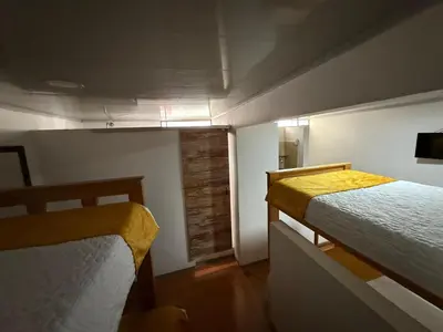 a small room with two beds and a window at Ayenda Marana in Manizales