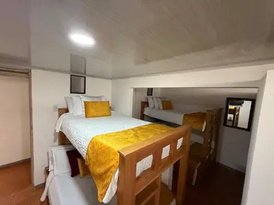 a bedroom with two beds in a small room at Ayenda Marana in Manizales