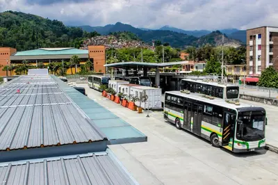 a group of buses parked at a bus station at Hermoso apartamento con terraza in Medellín