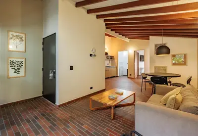 a living room with a couch and a table at The Somos Flats Laureles in Medellín