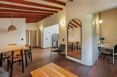 a living room and dining room with a table and chairs at The Somos Flats Laureles in Medellín