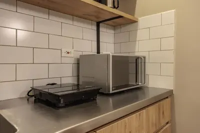 a microwave sitting on top of a kitchen counter at The Somos Flats Laureles in Medellín
