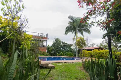 a pool in the garden of a house at APARTAMENTO CAMPESTRE EN EJE CAFETERO in Manizales