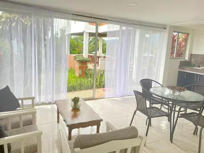 a living room with a table and chairs at APARTAMENTO CAMPESTRE EN EJE CAFETERO in Manizales