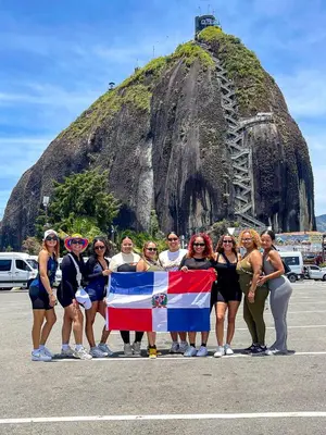 a group of people holding a flag in front of a mountain at Económica casa con piscina privada en Medellín MLB by Lets Go in Medellín