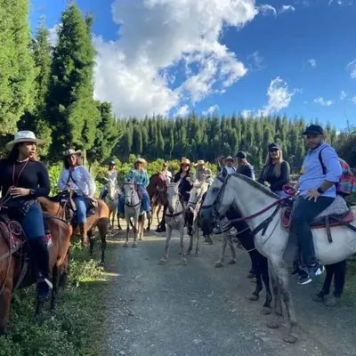 a group of people riding horses down a road at Económica casa con piscina privada en Medellín MLB by Lets Go in Medellín