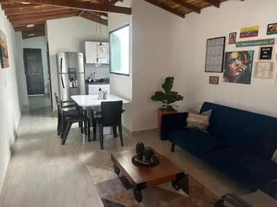 a living room with a blue couch and a table at Medellin Hermoso apartamento in Medellín
