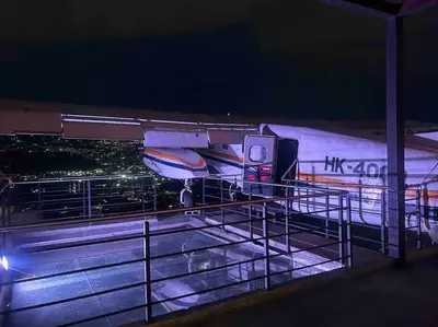 a plane is parked on a runway at night at Medellin Hermoso apartamento in Medellín