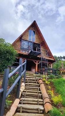 a staircase leading to a house with a balcony at Glamping Milagros in San Pedro