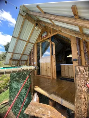 an outside view of a building with a wooden deck at Glamping Milagros in San Pedro