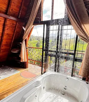 a bath tub in a room with a large window at Glamping Milagros in San Pedro
