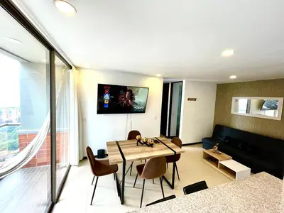 a living room with a table and a couch at Space, best location & price! in Medellín