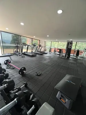 a gym with a lot of equipment in a room at Space, best location & price! in Medellín