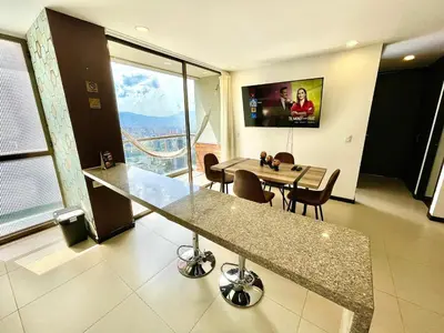 a room with a table and a dining room with a view at Space, best location & price! in Medellín