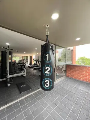a gym with a sign hanging from the ceiling at Space, best location & price! in Medellín