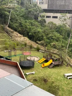 an outdoor playground with slides and play equipment in a park at Space, best location & price! in Medellín