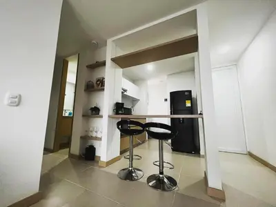 a kitchen with two black stools in a room at Hermoso apartamento la Francia 3 habitaciones in Manizales