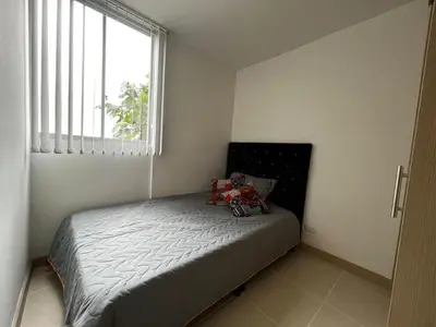 a small bedroom with a bed with a window at Hermoso apartamento la Francia 3 habitaciones in Manizales
