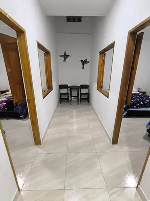 a hallway with a table and chairs in a room at Apartahotel La Gruta in Jericó