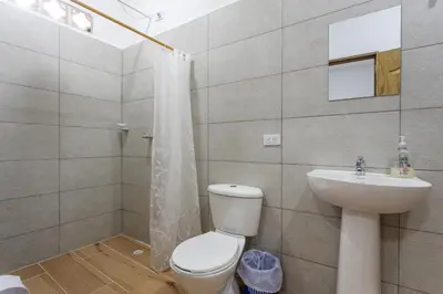 a bathroom with a toilet and a sink at Apartahotel La Gruta in Jericó